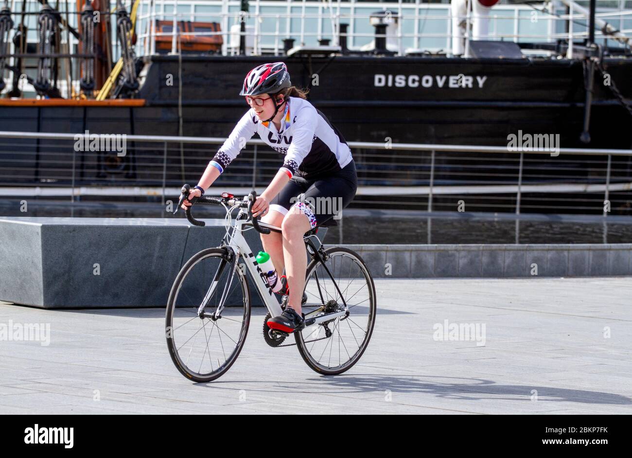 Dundee, Tayside, Scotland, UK. 5th May, 2020. UK Weather: Warm and sunny morning in Dundee with temperatures reaching 14°C. A female cyclist enjoying the warm sunny weather while taking outdoor exercises cycling past RRS Discovery ship along the waterfront during the Covid-19 lockdown restrictions throughout Scotland. Credit: Dundee Photographics/Alamy Live News Stock Photo