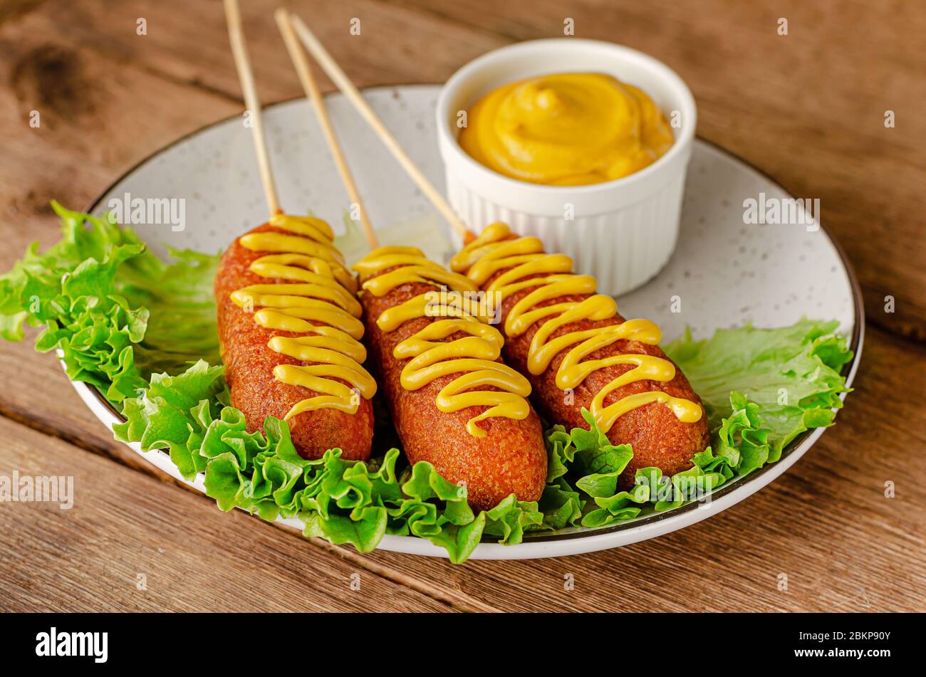 Deep fried corn dogs on wooden background. Top view, overhead Stock