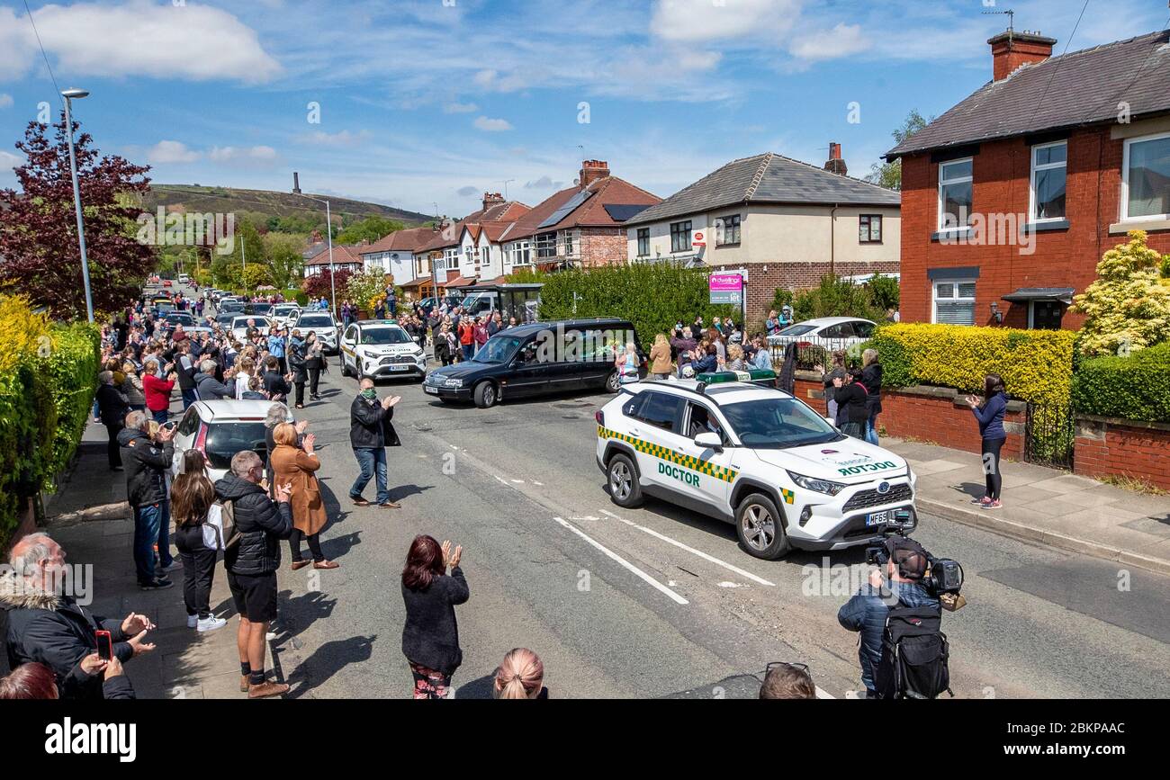 The hearse carrying the body of Dr Saad AlDubbaisi passes Garden City