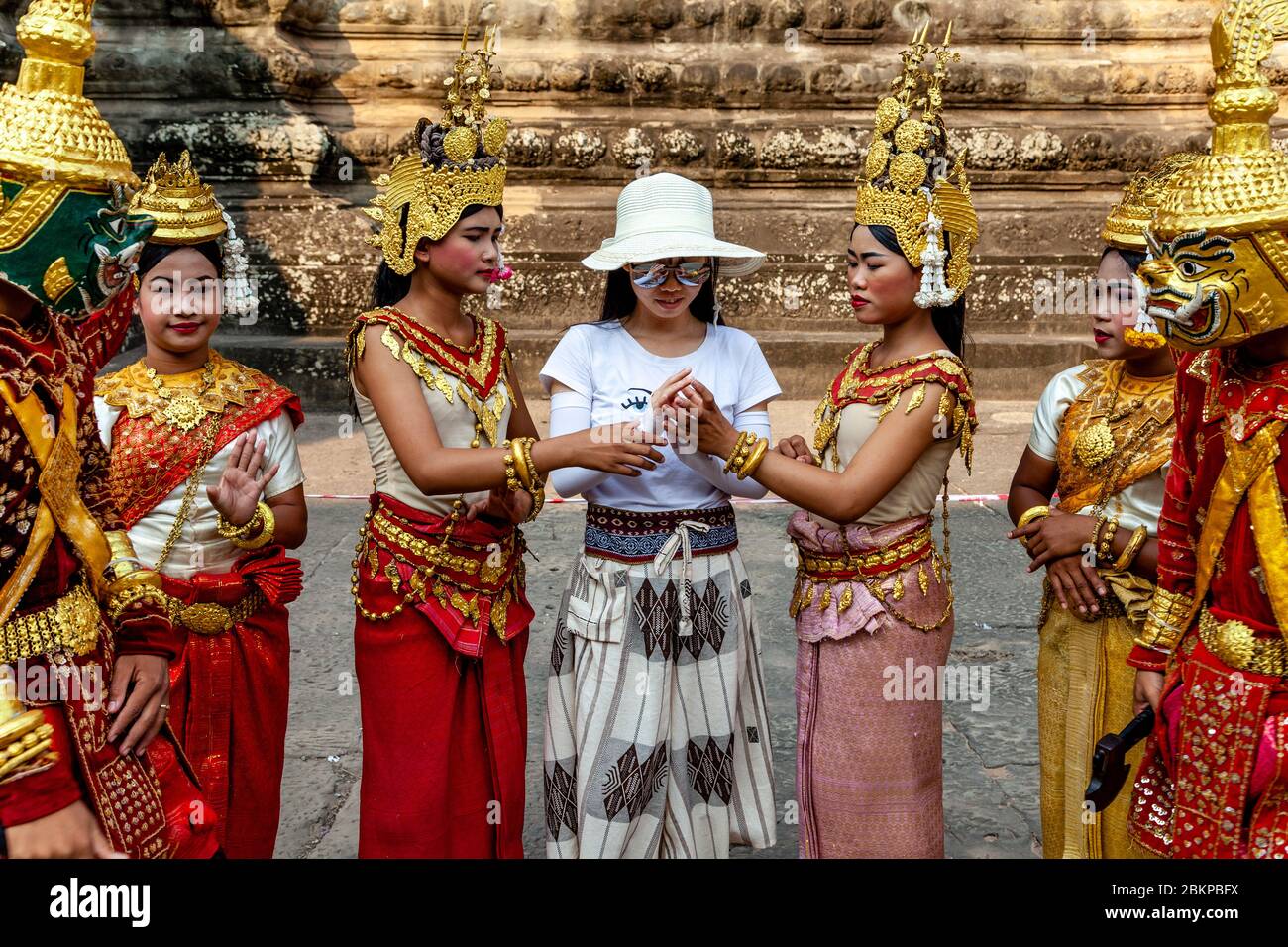 Young Cambodian Women In Traditional Costume Interacting With A