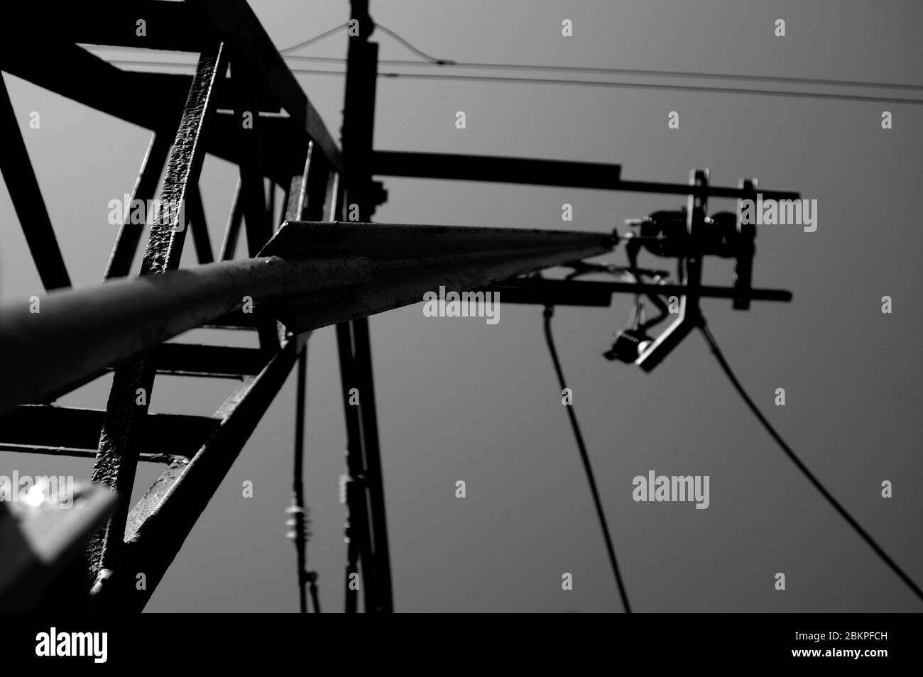 Power electricity wire for trains against sky. Close up of railway electrification system Stock