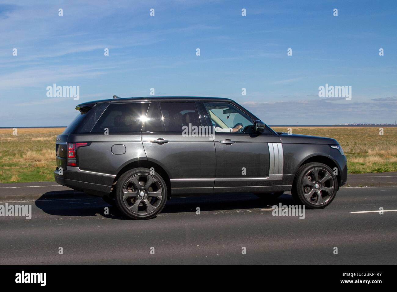 2015 grey LAND ROVER RANGE ROVER DIESEL ESTATE 4.4 SDV8 Autobiography 4dr Auto; Vehicular traffic moving vehicles, driving vehicle on UK roads, motors, motoring on the coast road, Southport Merseyside UK Stock Photo