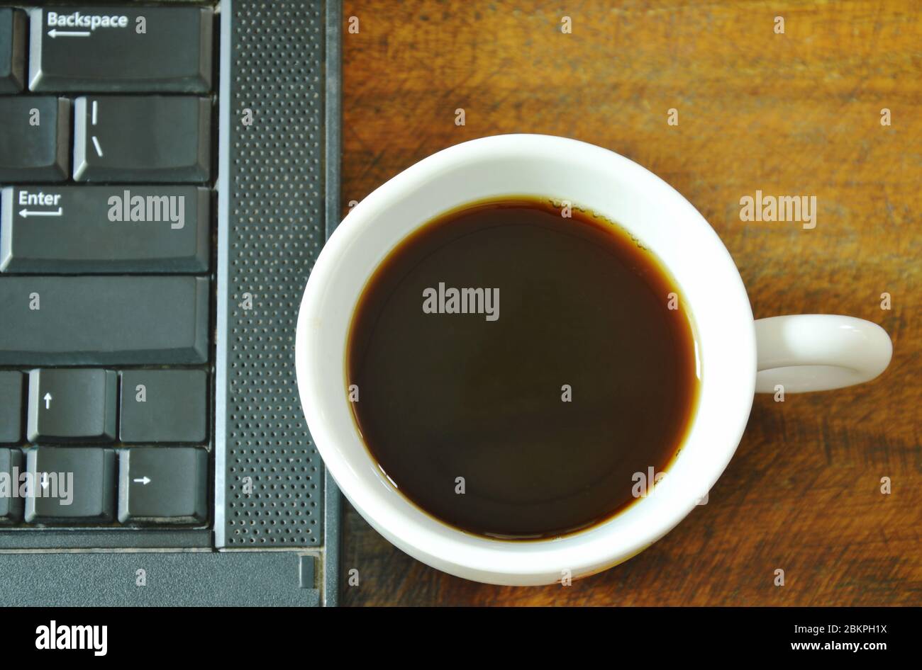 Cup Using Computer computer notebook and black coffee cup on table Stock Photo - Alamy