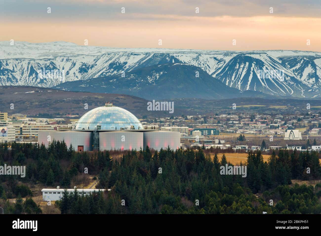 Perlan, landmark building in Reykjavík, the capital of Iceland with snowy mountains in the background, seen from the tower of Hallgrimskirkja church. Stock Photo