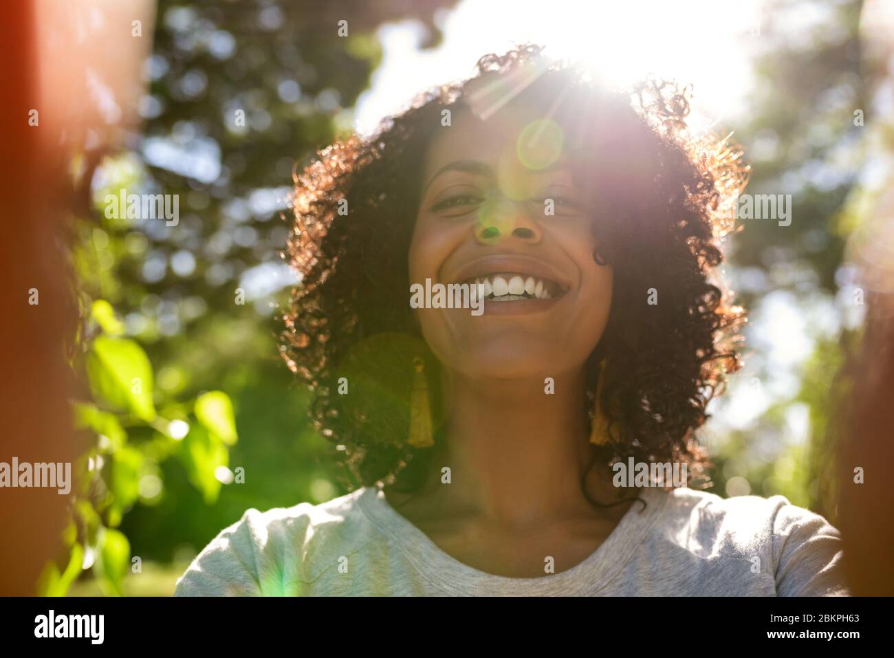 Laughing woman taking a selfie outside on a sunny day Stock Photo