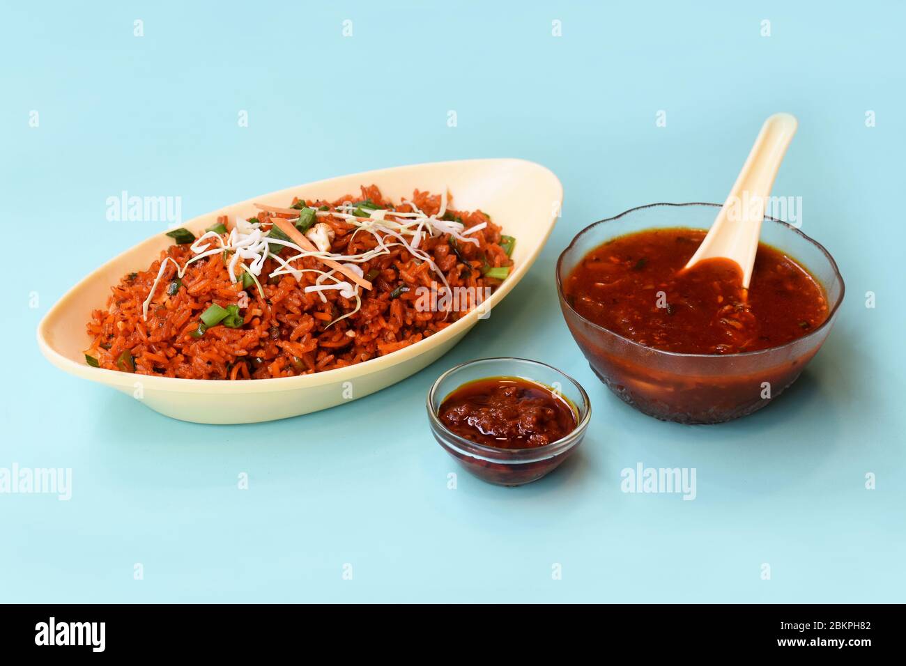 Schezwan fried rice with schezwan sauce, Chinese fried rice,garnished with spring onion and cabbage.indo chinese cuisine dishes.selective focus Stock Photo