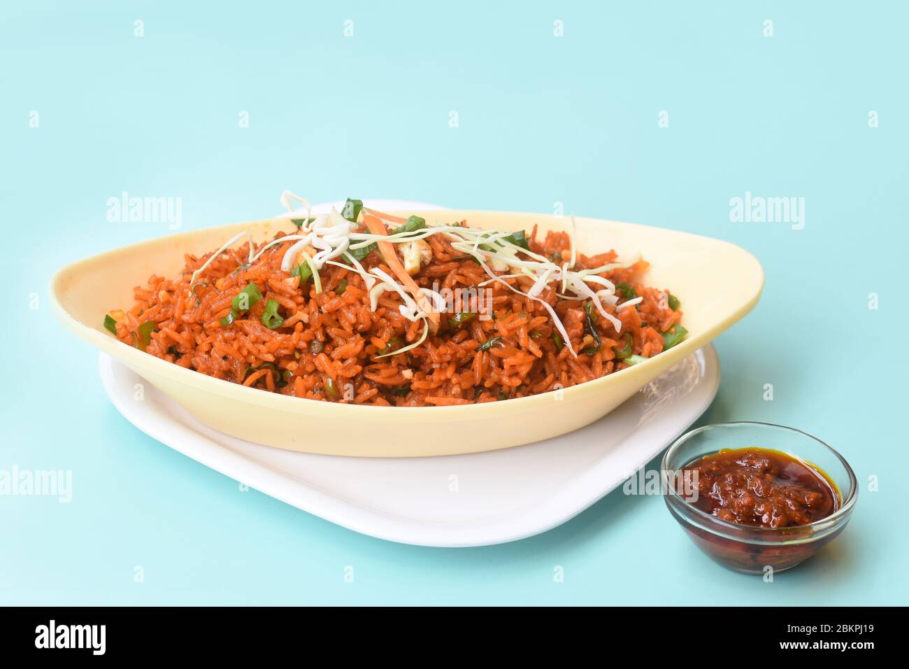 Schezwan fried rice with schezwan sauce, Chinese fried rice,garnished with spring onion and cabbage.indo chinese cuisine dishes.selective focus Stock Photo