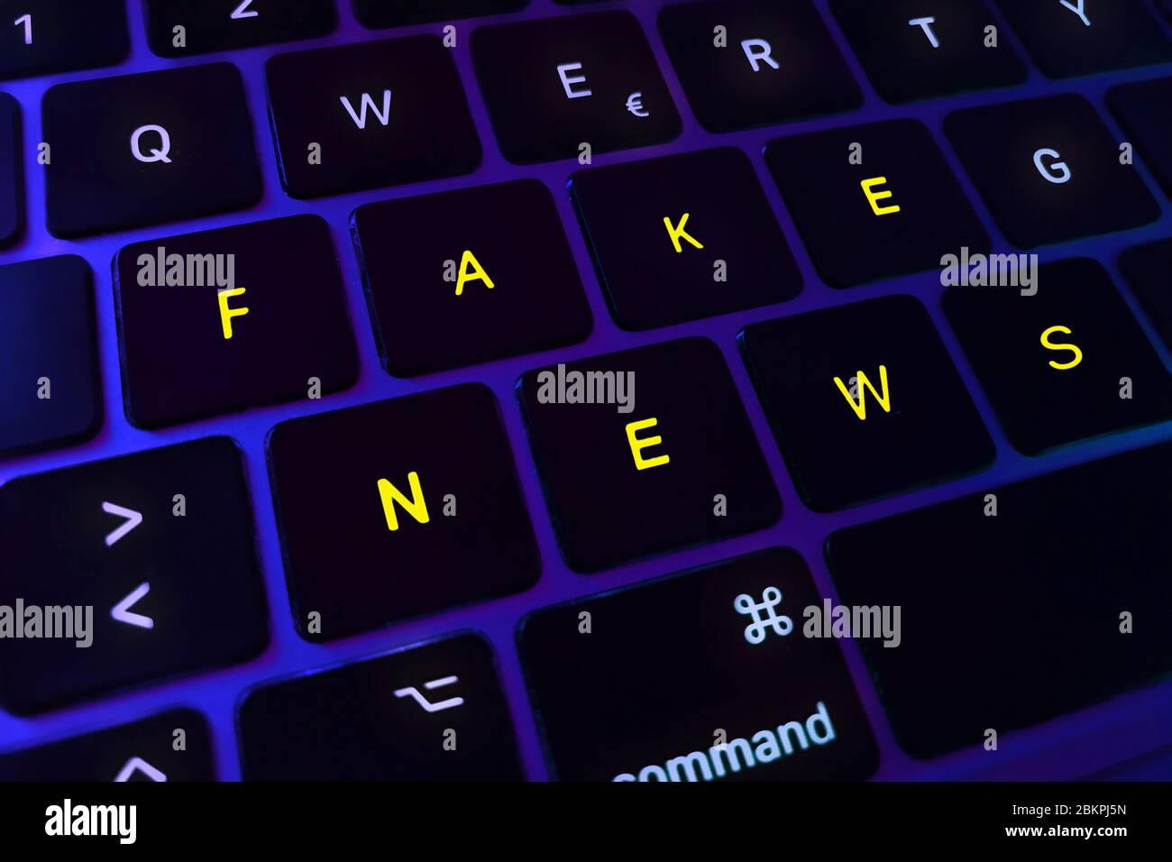 Concept about fake news. Fake news text written on a laptop keyboard. Concept about disinformation, manipulated news and propaganda. Stock Photo