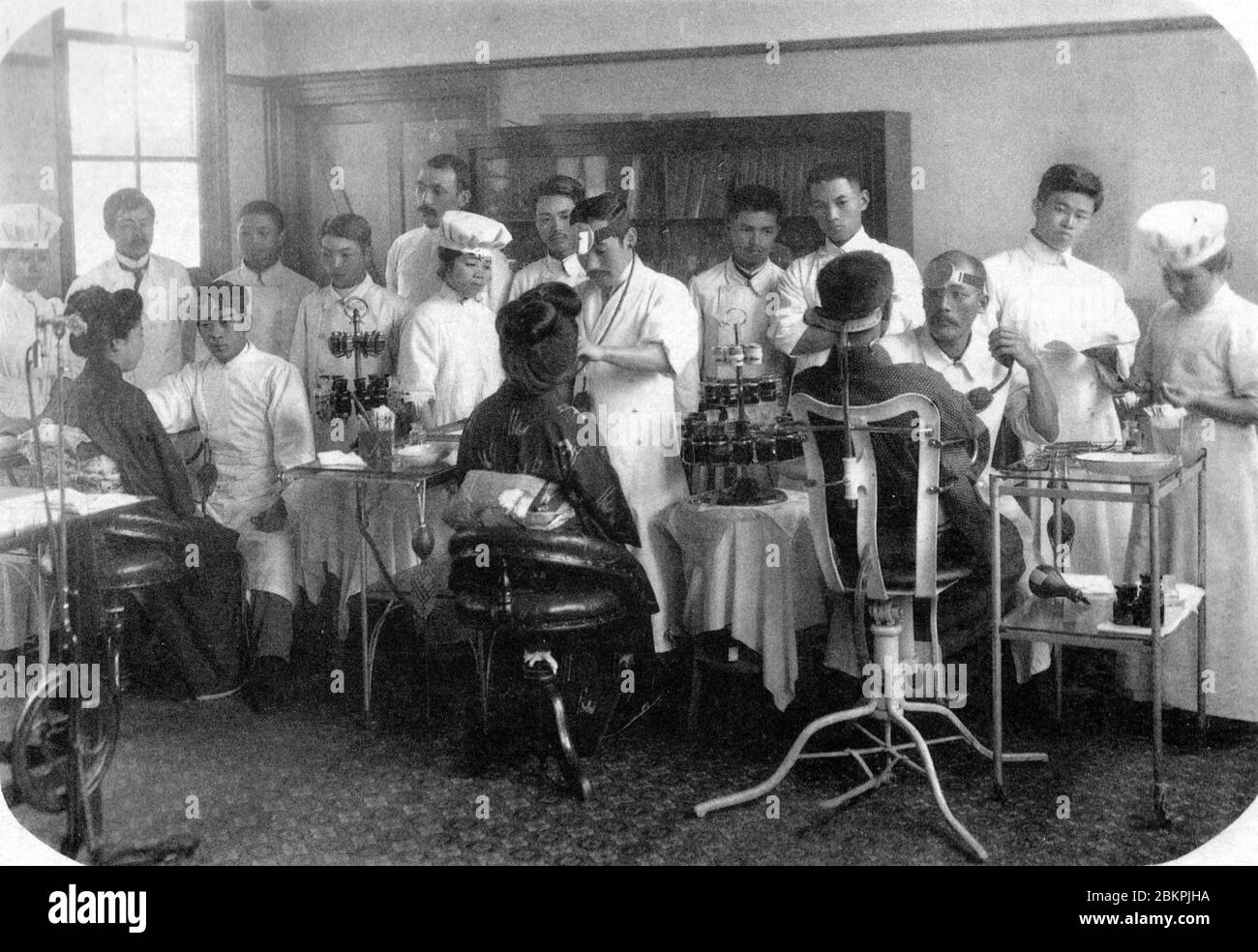 [ 1910s Japan - Japanese Doctors and Patients ] —   Doctors-to-be and nurses attend to patients at Okayama Iigakku Senmon Gakko, a medical school in Okayama, in 1910 (Meiji 34).  20th century vintage gelatin silver print. Stock Photo