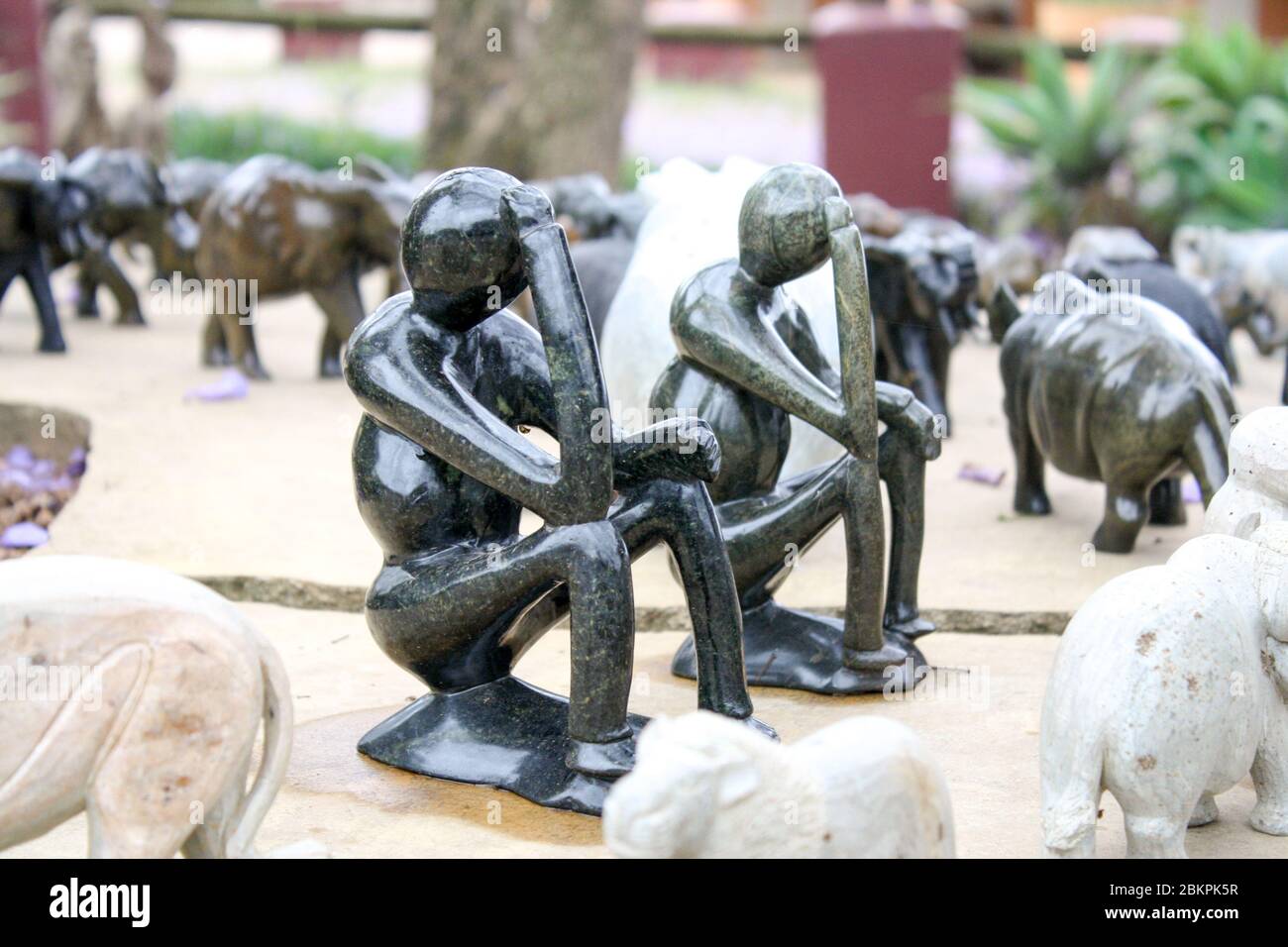 Soft stone made replica of wise men thinking. In rural Africa, wise men are respected very much and they are a popular subject for art. Stock Photo