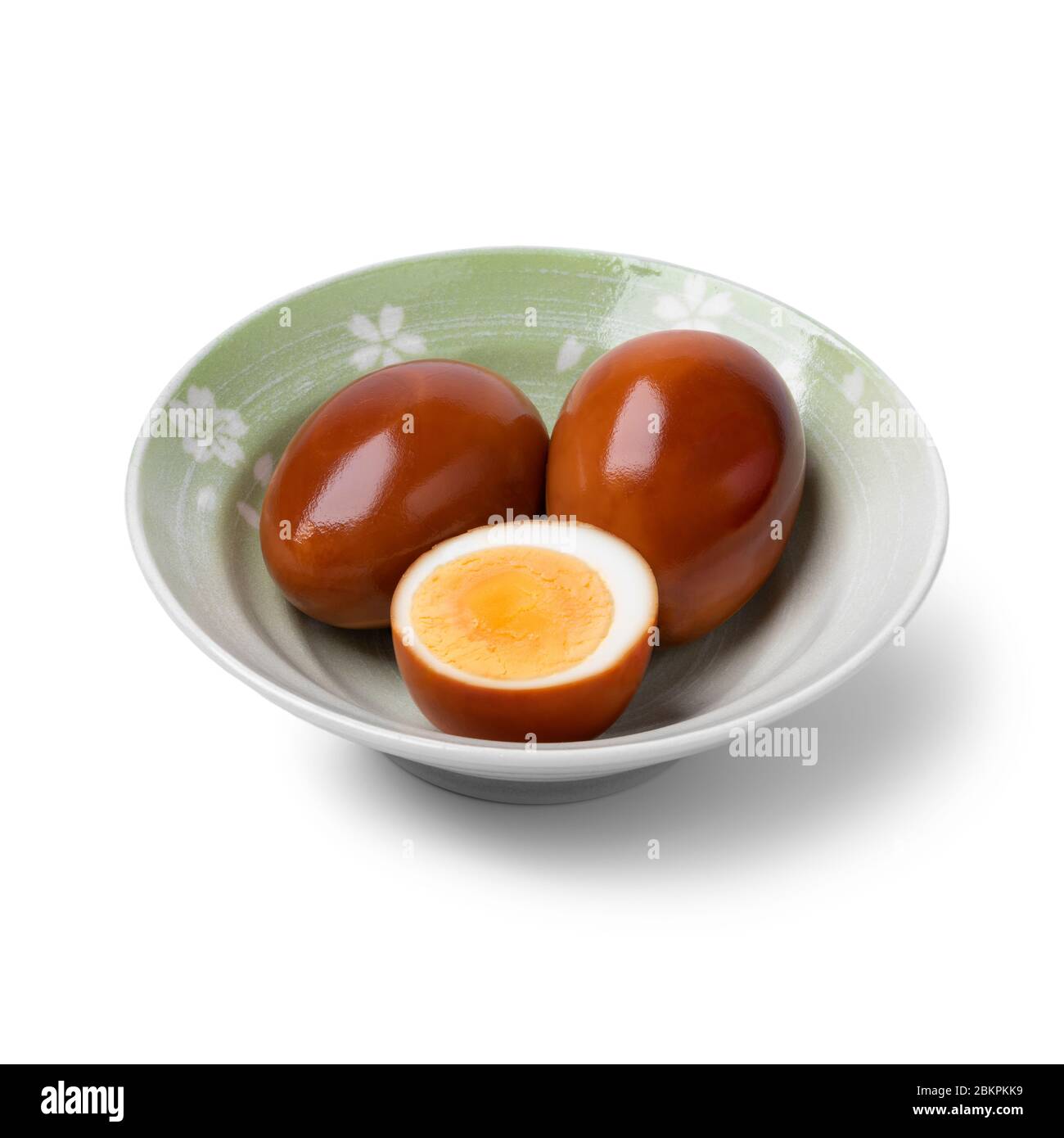 Bowl with whole and half soy sauce eggs, Shoyu tamago isolated on white background Stock Photo