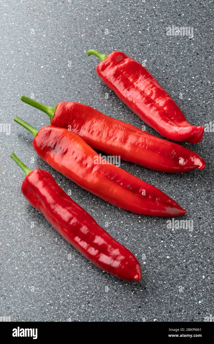 Group of whole fresh red sweet pointed peppers Stock Photo