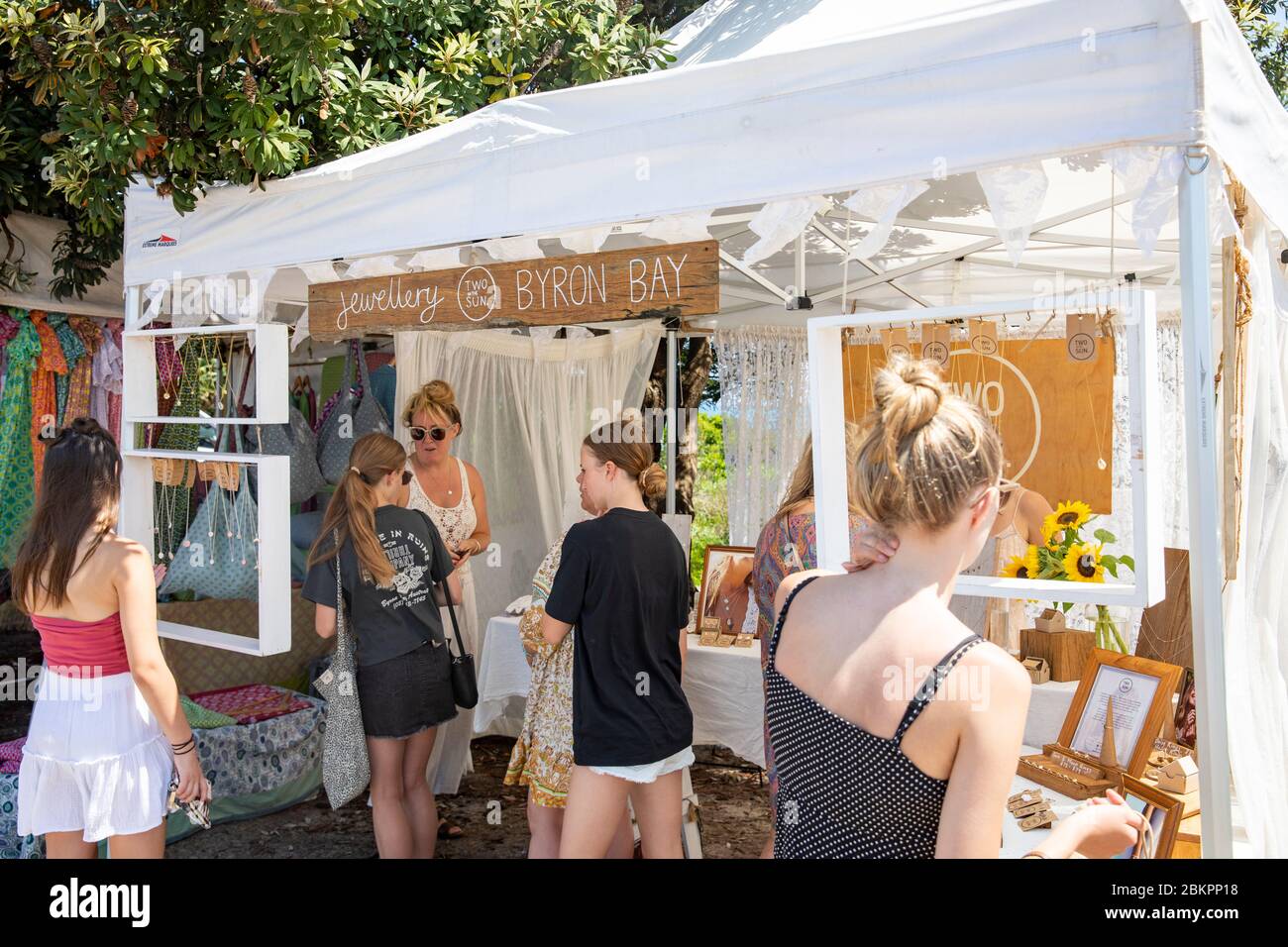 Byron Bay saturday market and young teenage girls trying on jewellery at a stall, New South Wales,Australia Stock Photo