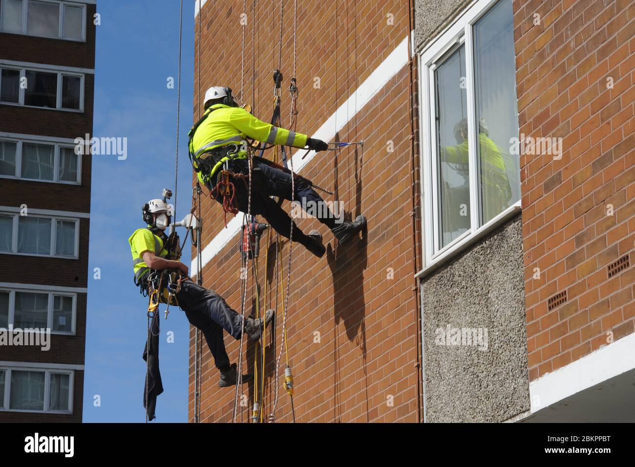 Men working at height on ropes. Industrial rope access workers on the