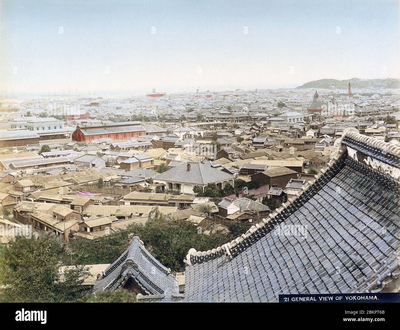 [ 1890s Japan - View of Yokohama ] —   Panoramic view of Yokohama sometime in the 1890s as seen from Narita-san Enmei-in Temple.  The twin buildings on the left are Yokohama Station, opened in 1871 (Meiji 4). The tower in right behind the roof of the temple is the Yokohama Shiloh Church (横浜指路教会), built in 1892 (Meiji 25).  Compare this photo with 70507-0033 – View of Yokohama, shot from the same location around 1881 (Meiji 14).  19th century vintage albumen photograph. Stock Photo