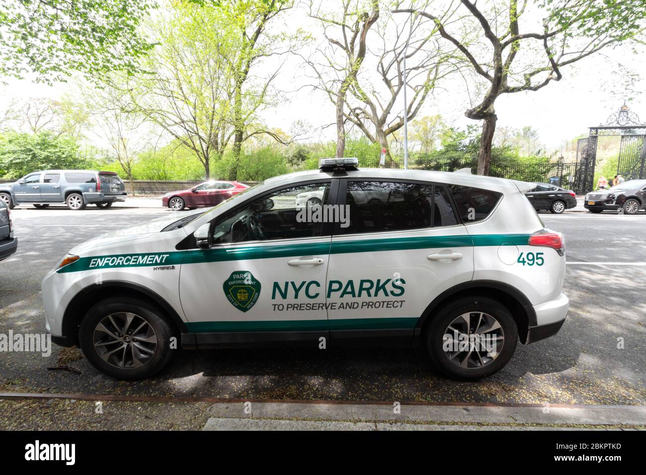 car belonging to the NYC Parks Enforcement Patrol parked on 5th Ave. next to Central Park. The Patrol enforces parks rules and regulations. Stock Photo