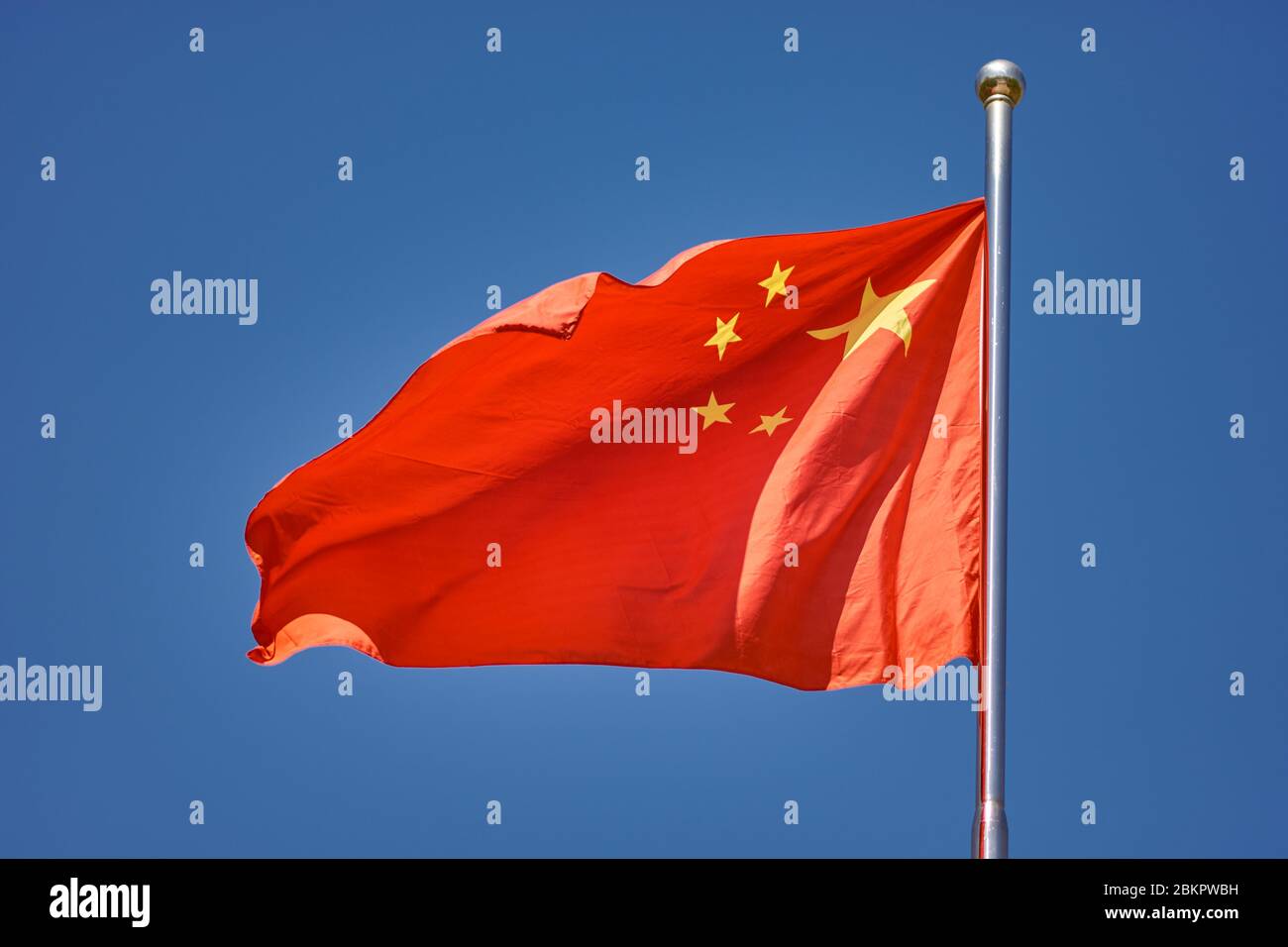 Flag of the Peoples Republic of China against the clear blue sky Stock Photo