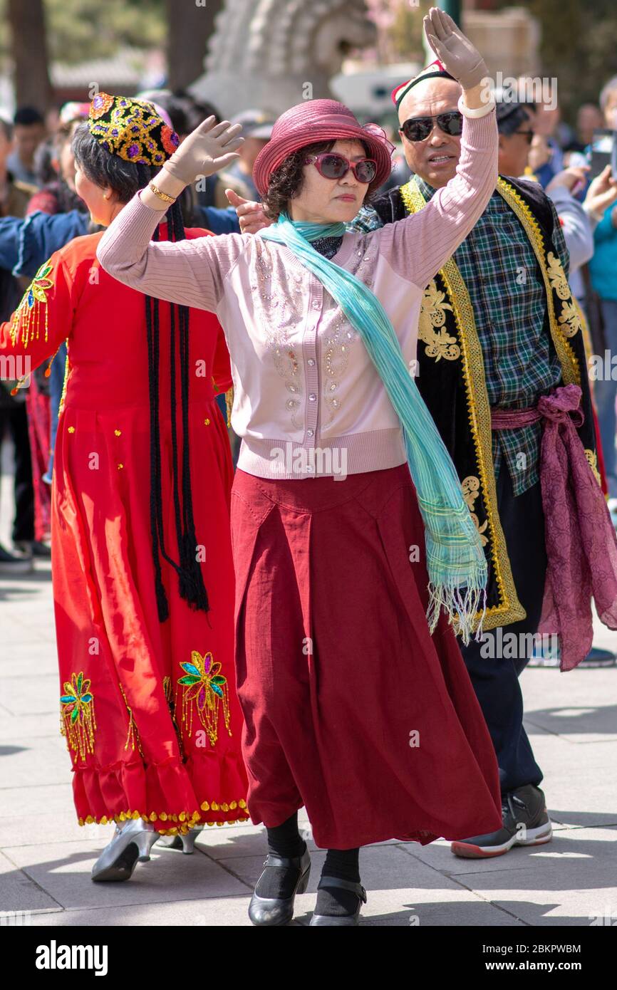 Beijing / China - April 2, 2016: Chinese Hui Muslims dancing traditional dance in Beihai park in Beijing, China Stock Photo