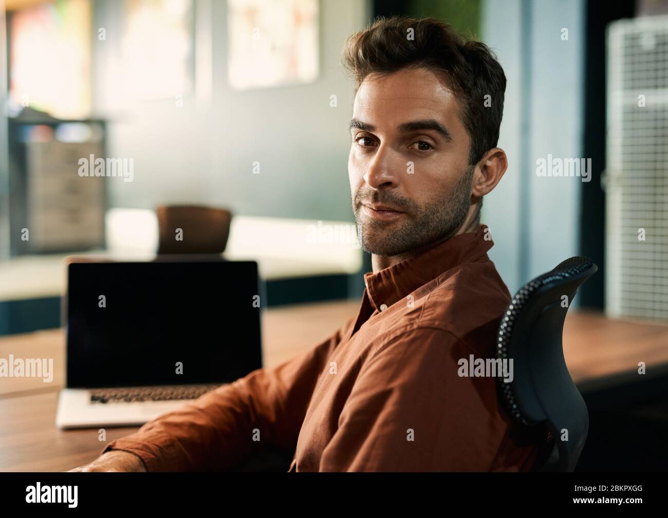 Businessman working late at a desk in an office Stock Photo