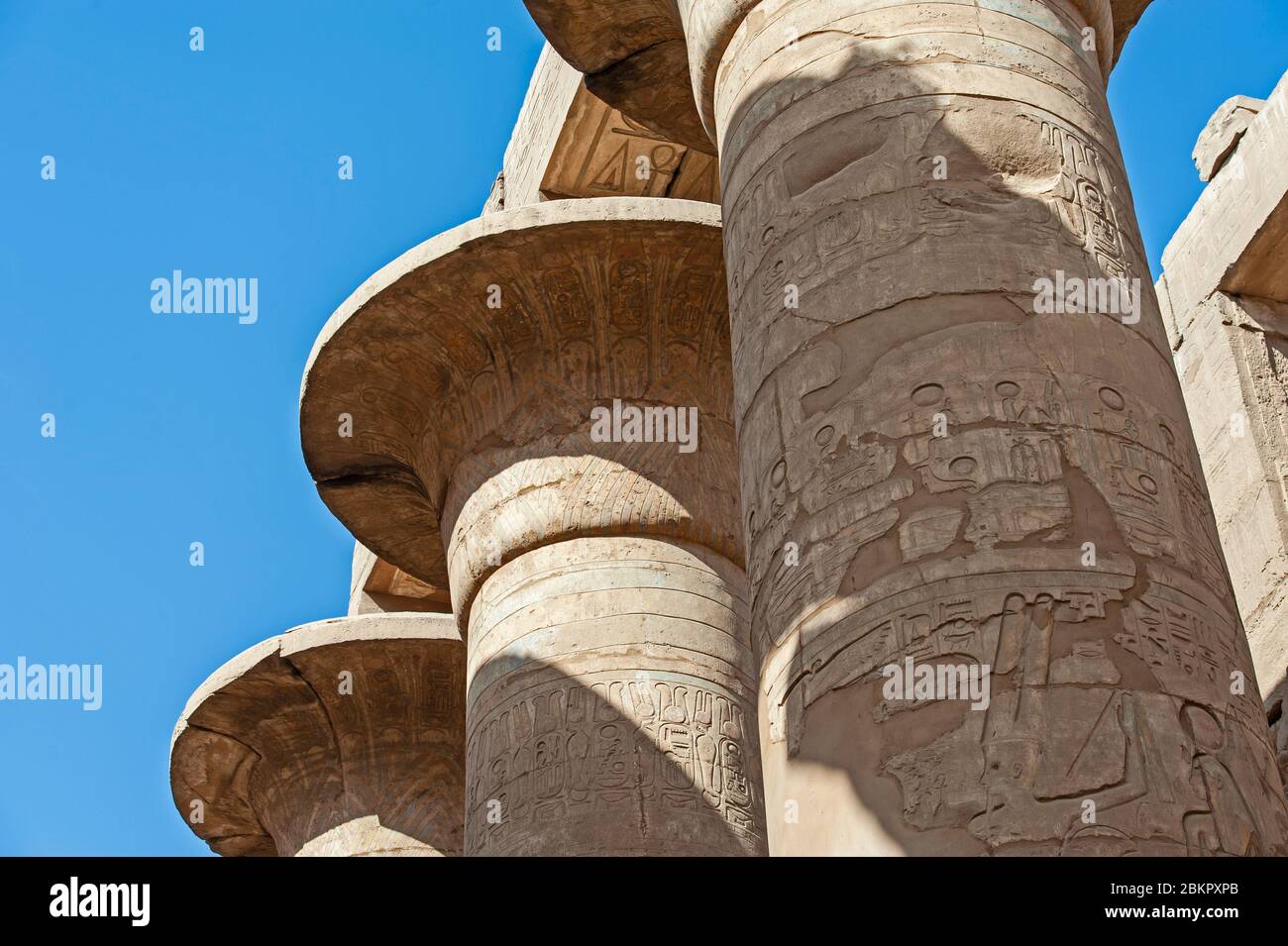 Hieroglypic carvings on columns at the ancient egyptian hypostyle hall of Karnak temple in Luxor Stock Photo