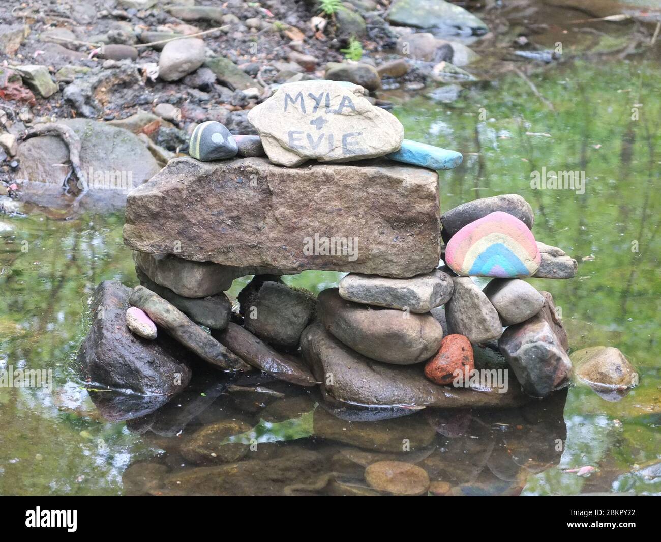 Painted stones with messages of gratitude for NHS at secret 'fairy garden' by river in Sheffield, UK, which has sprung up during Coronavirus Lockdown Stock Photo