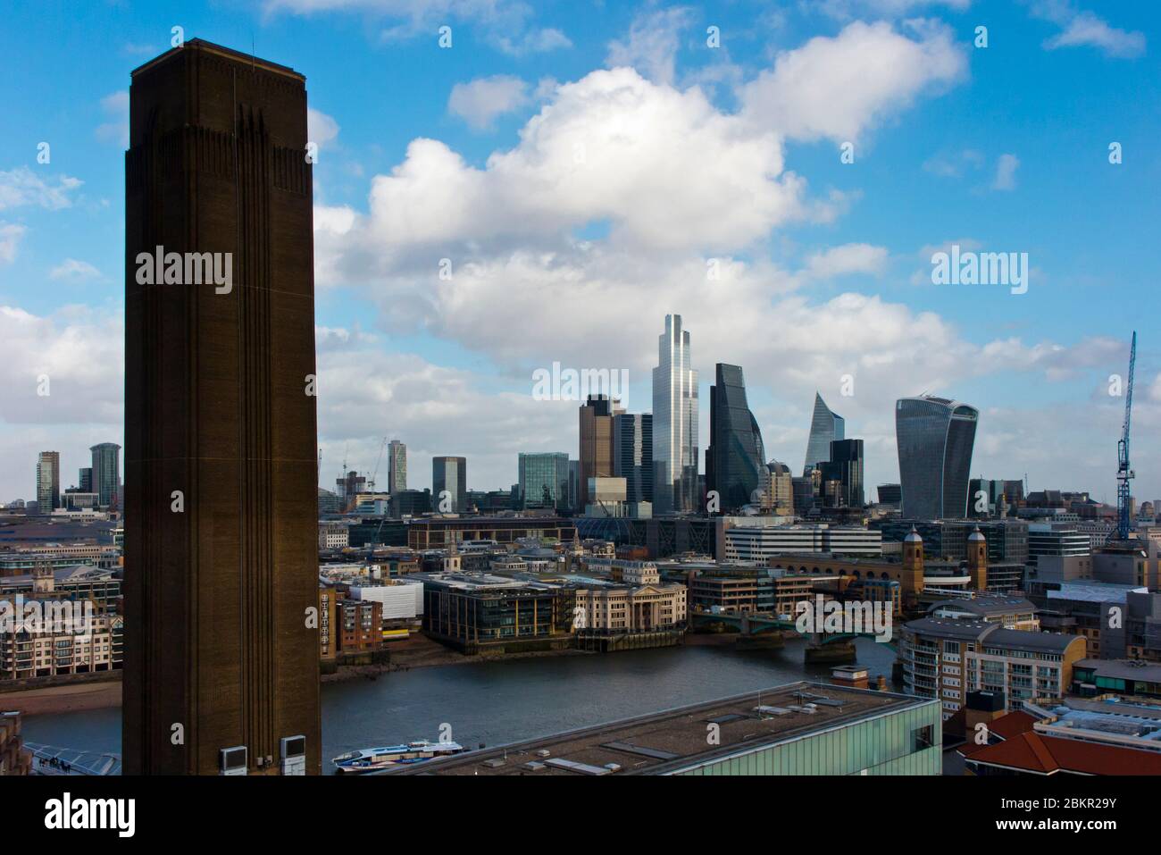 View of the City of London financial district skyline with the chimney block of the Tate Modern Art Gallery in the foreground. Stock Photo