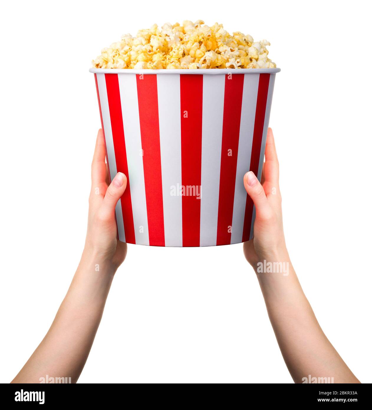 Woman holding striped popcorn bucket with two hands isolated on white