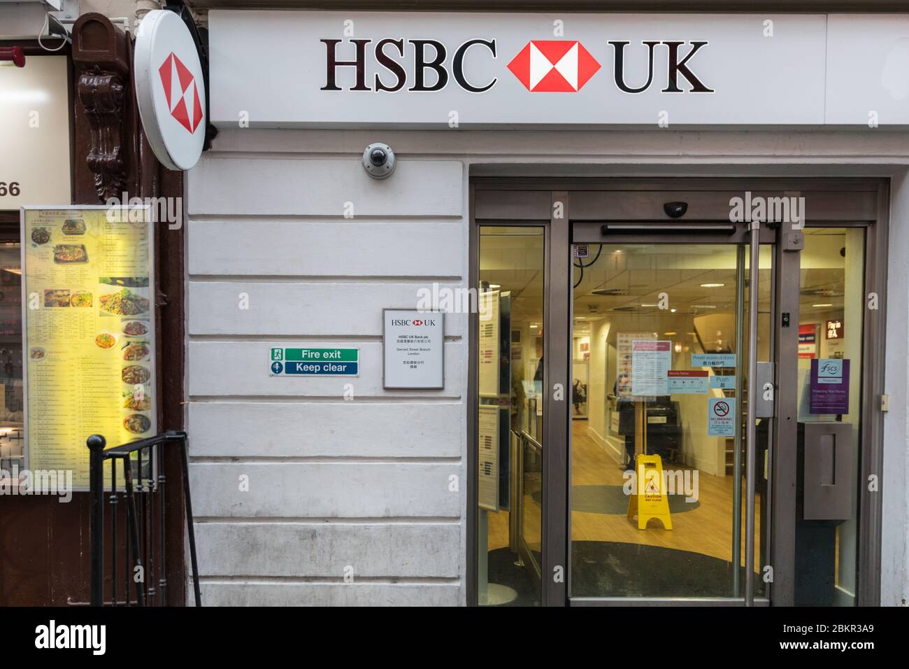 Chinese branding name letters and corporate logo of HSBC bank branch Chinatown, Gerrard Street, London, UK Stock Photo