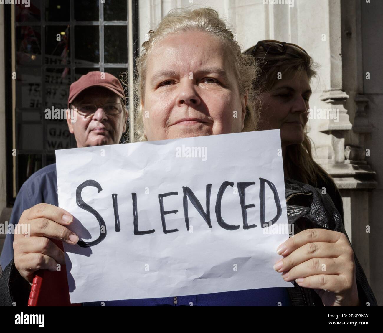 Female protester with 'Silenced' sign protesting against prorogation of Parliament outside the Supreme Court of the United Kingdom in London Stock Photo