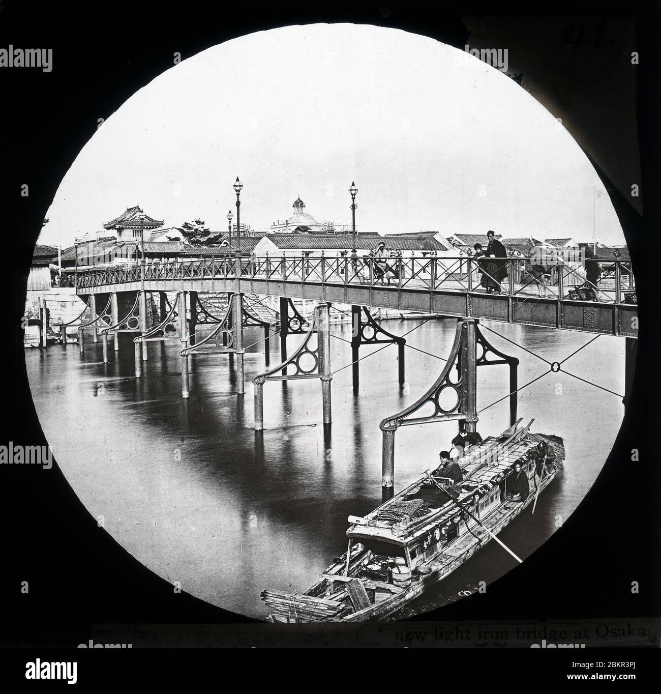 [ 1870s Japan - First Iron Bridge in Osaka ] —   Koraibashi Bridge (高麗橋) over the Higashiyokobori River in Osaka.  In 1870 (Meiji 3), the original wooden bridge was replaced by an iron bridge built by Nagasaki based Alt & Co. It was the first iron bridge in Osaka.  This photograph was taken shortly after the bridge was completed.  In 1929 (Showa 4), the iron bridge was replaced with a concrete structure.  19th century vintage glass slide. Stock Photo