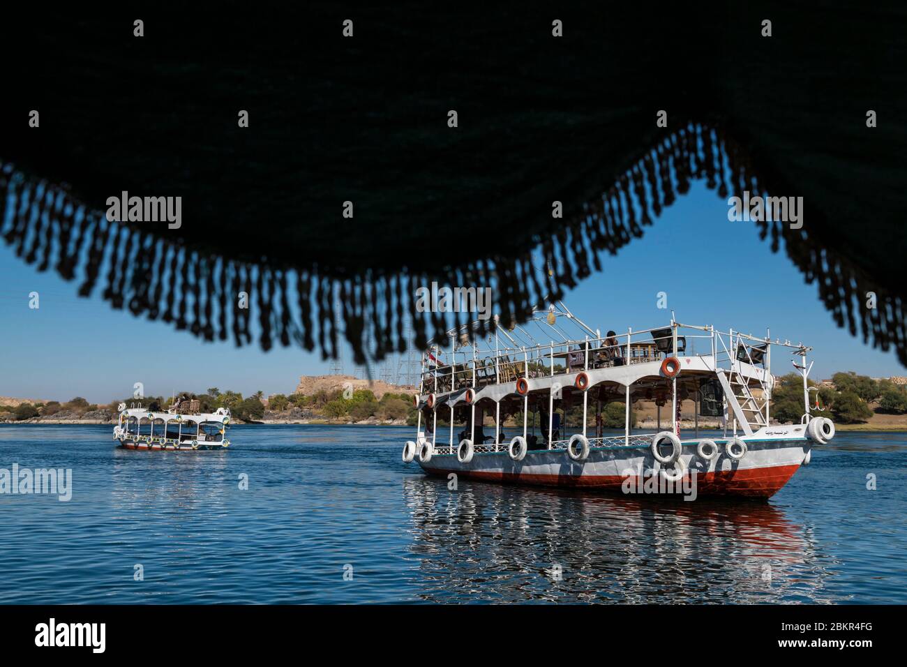 Egypt, Upper Egypt, Nile valley, Aswan, touristic boats on the Nile near Nubian village Stock Photo