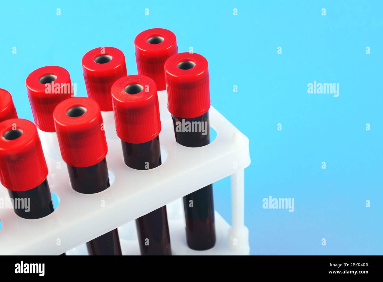 blood collection vacuum tubes on a blue background with place for text