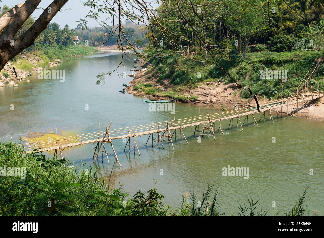 Laos, Luang Prabang city classified UNESCO world heritage, bamboo bridge over Nam Khan river Stock Photo