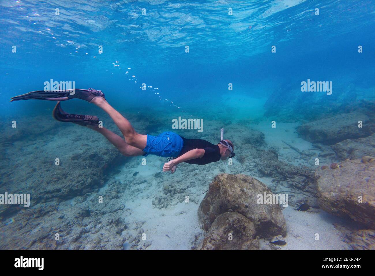 Seychelles, Grande Soeur island, man tuba diving in turquoise sea Stock Photo