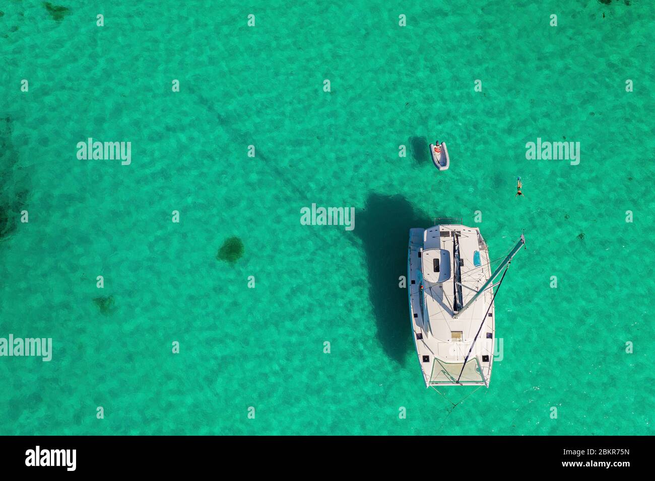 Seychelles, Cerf island, boat mooring and woman swimming (aerial view ...