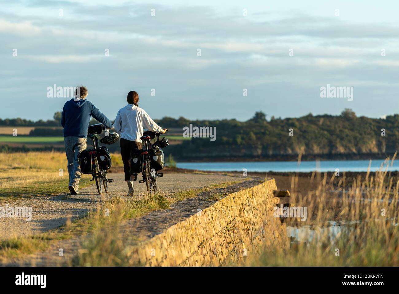 France, C?tes d'Armor, Paimpol, cycle tourists in front of Beauport Abbey at daybreak, along the Maritime Bicycle route Stock Photo