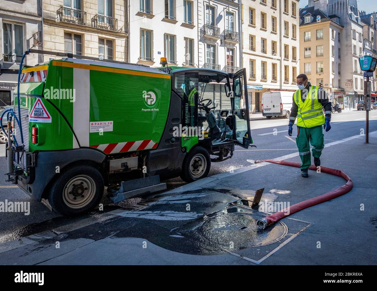 France, Paris, COVID-19 (or Coronavirus) lockdown, municipal cleaning service, worker wearing with a face mask Stock Photo