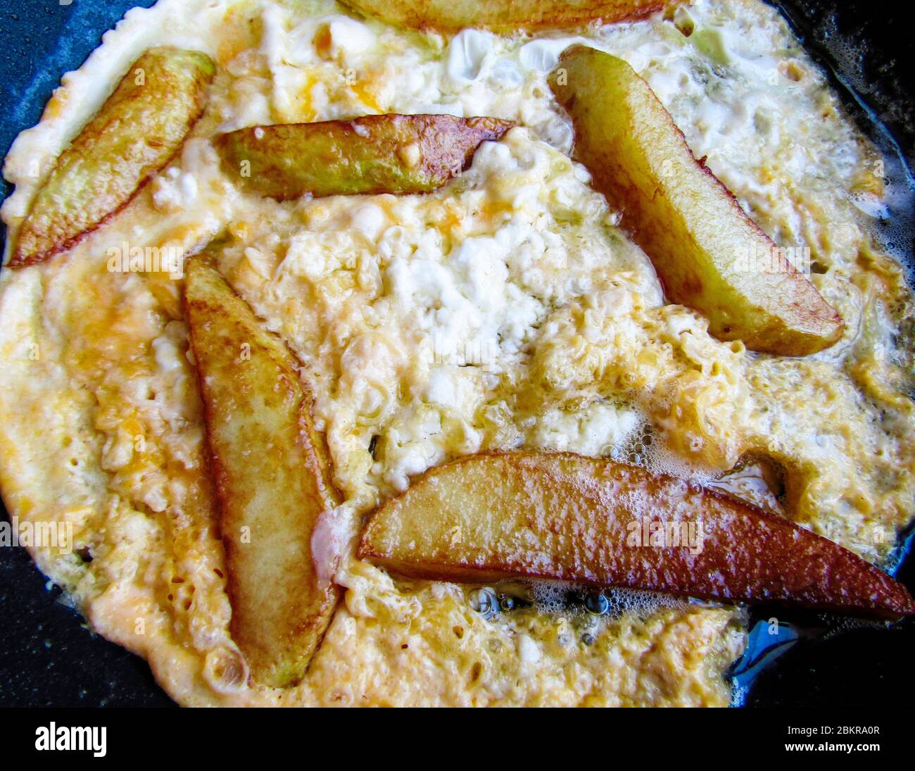 Greek Cuisine. Scrambled Eggs with Feta Cheese and French Fries Stock