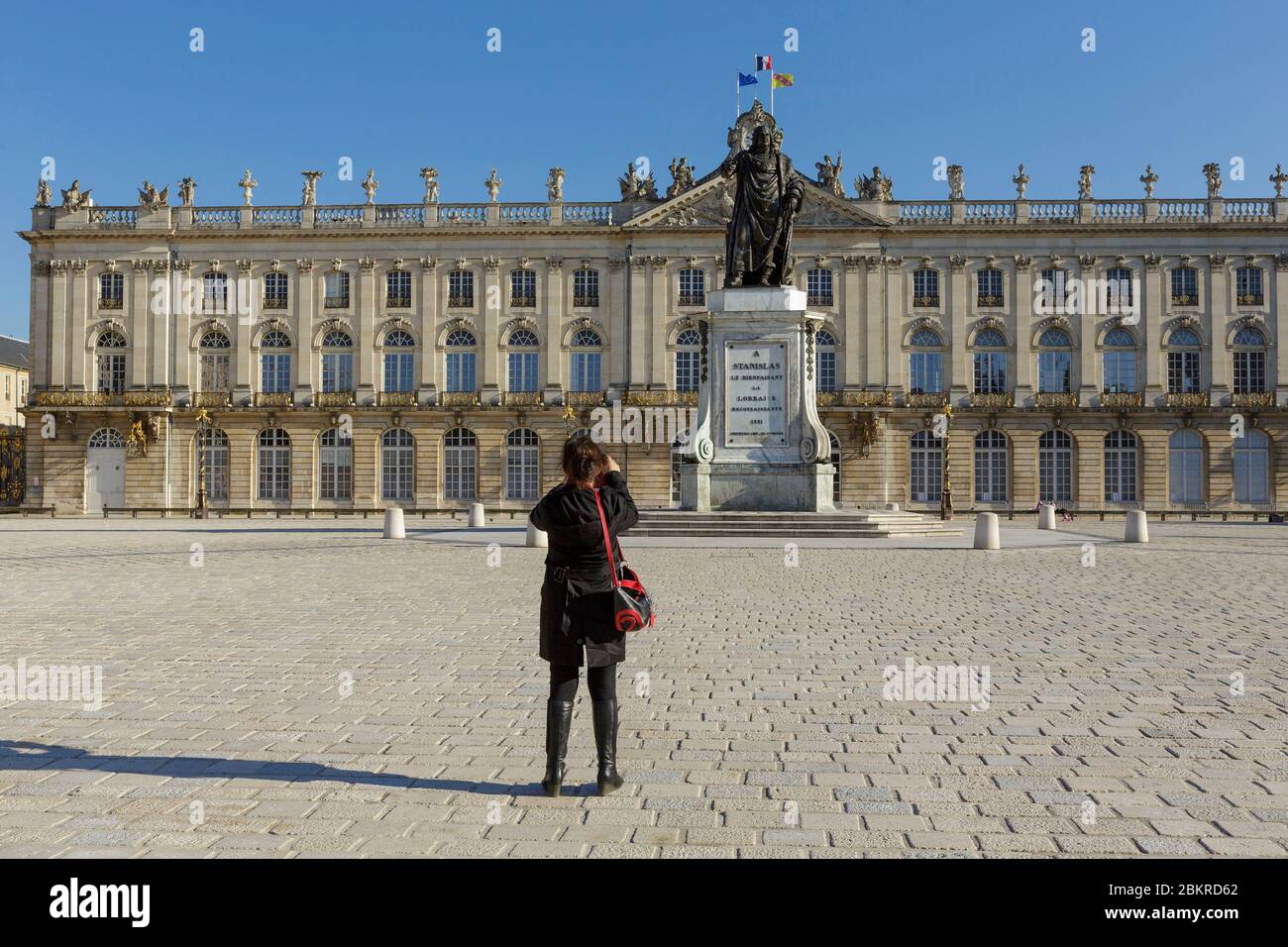 France, Meurthe et Moselle, Nancy, Covid 19 or Coronavirus lockdown, Stanislas square (former royal square) built by Stanislas Lescynski, king of Poland and last duke of Lorraine in the 18th century, listed as World Heritage by UNESCO, facade of the townhall, statue of Stanislas, railings and street lamps by Jean Lamour Stock Photo
