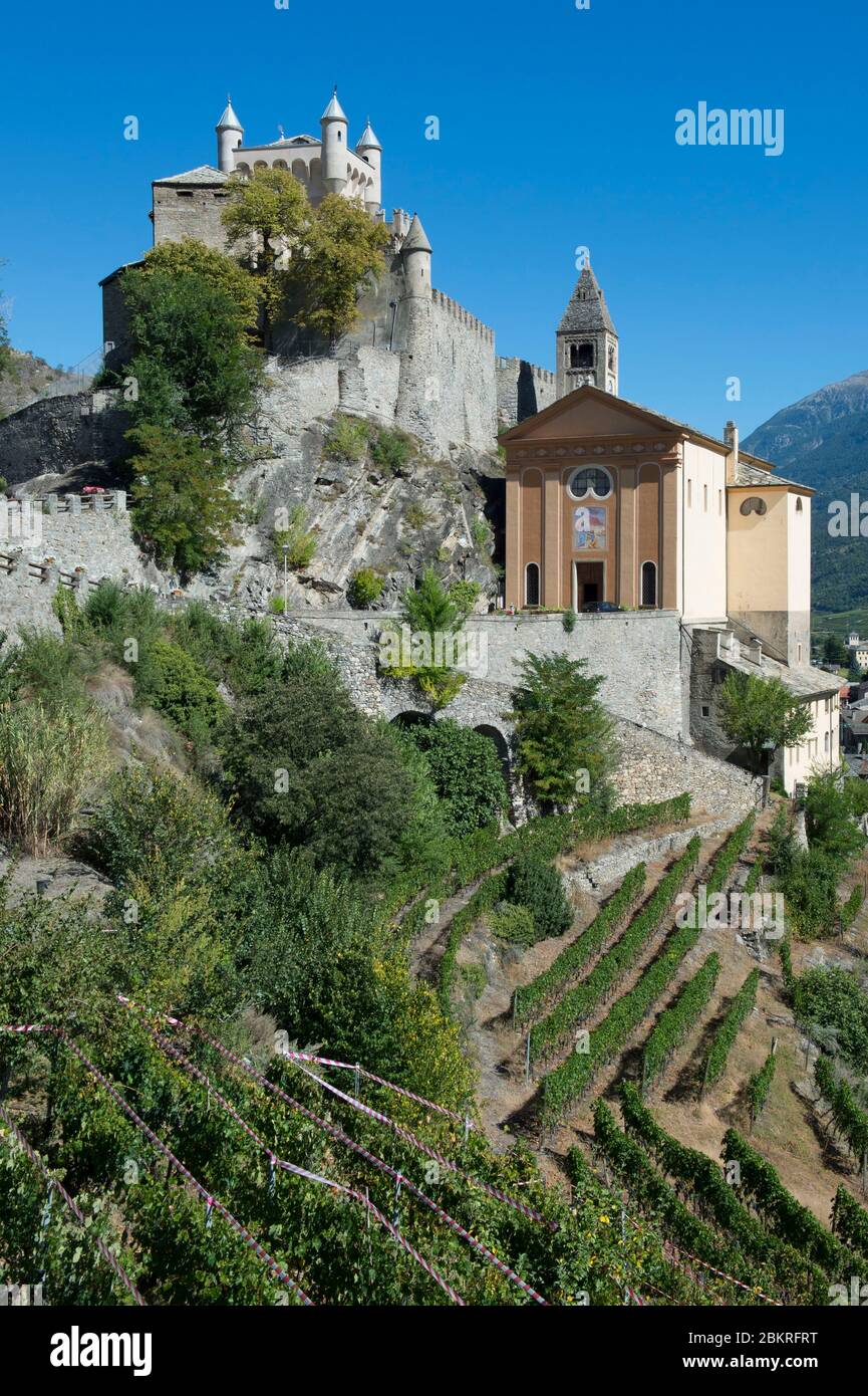 Italy, Aosta Valley, the castle and the Church of Saint Peter surrounded by vineyards Stock Photo
