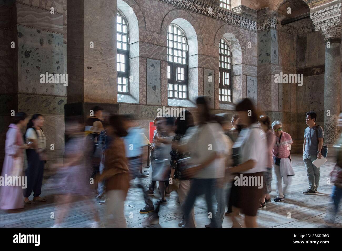 Turkey, Istanbul, the mosque basilica saint Sophie in work, group of asian tourists passing in front of the column in power of healing saint Gregoire Stock Photo