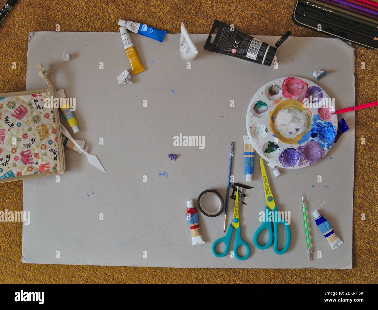 Child's art workspace with paints and brushes. Stock Photo