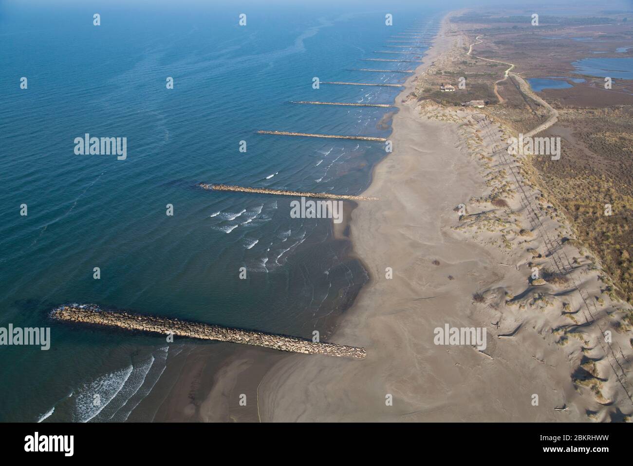 France, Gard, Camargue, Le Grau du Roi, beach east of Espiguette, dikes of rocky blocks erected after the storm of 1982 to delay the erosion and the retreat of the coast between the small Rhone and the lively Rhone (aerial view) Stock Photo