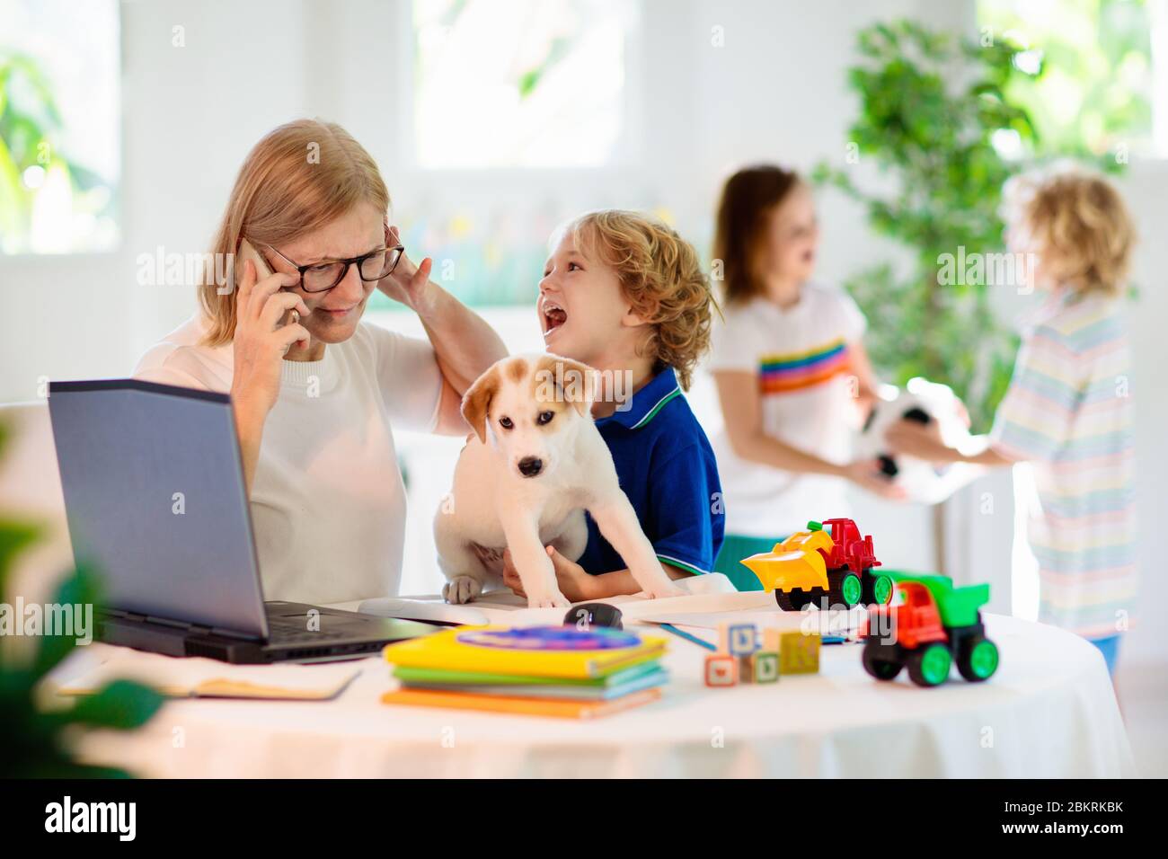 Mother working from home with kids. Homeschooling and home office ...