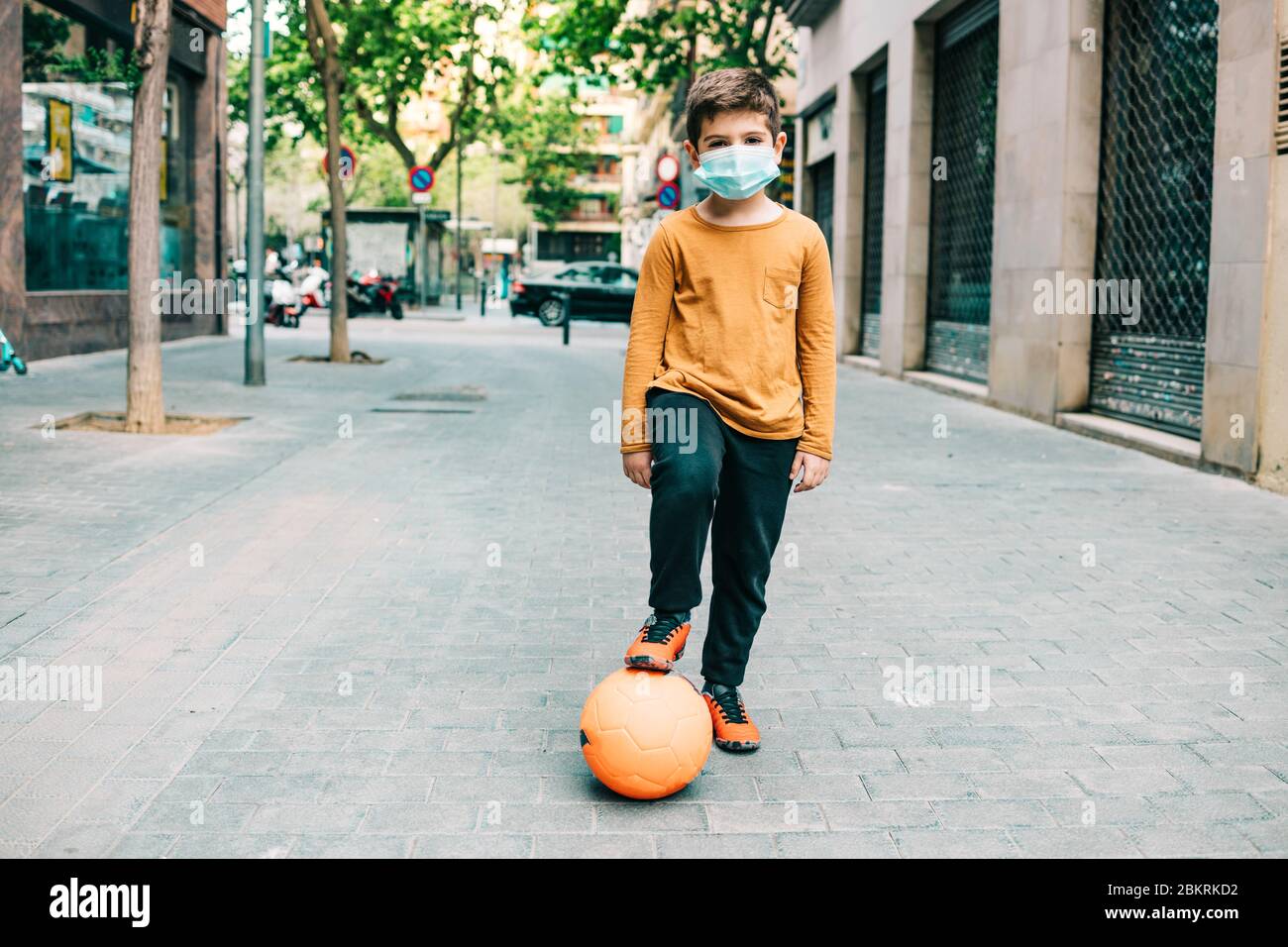 Little boy playing football with a mask Stock Photo Alamy