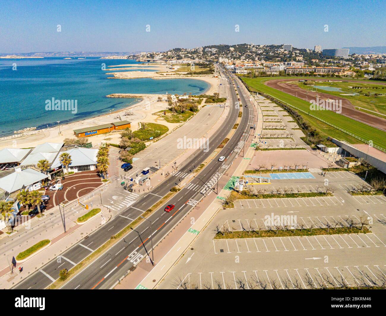 France, Bouches du Rhone, Marseille, Covid-19 or Coronavirus lockdown, the Prado beaches deserted following their closure by decree, avenue Pierre Mendes France and the empty parking lot of the Marseille Borely racetrack (aerial view) Stock Photo