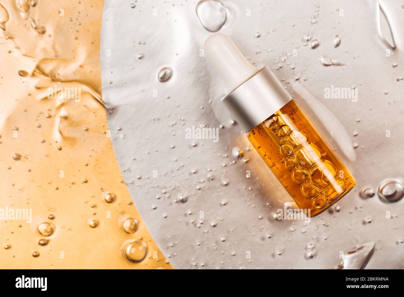 Bottle of hyaluronic acid on background with oxygen bubbles. Stock Photo