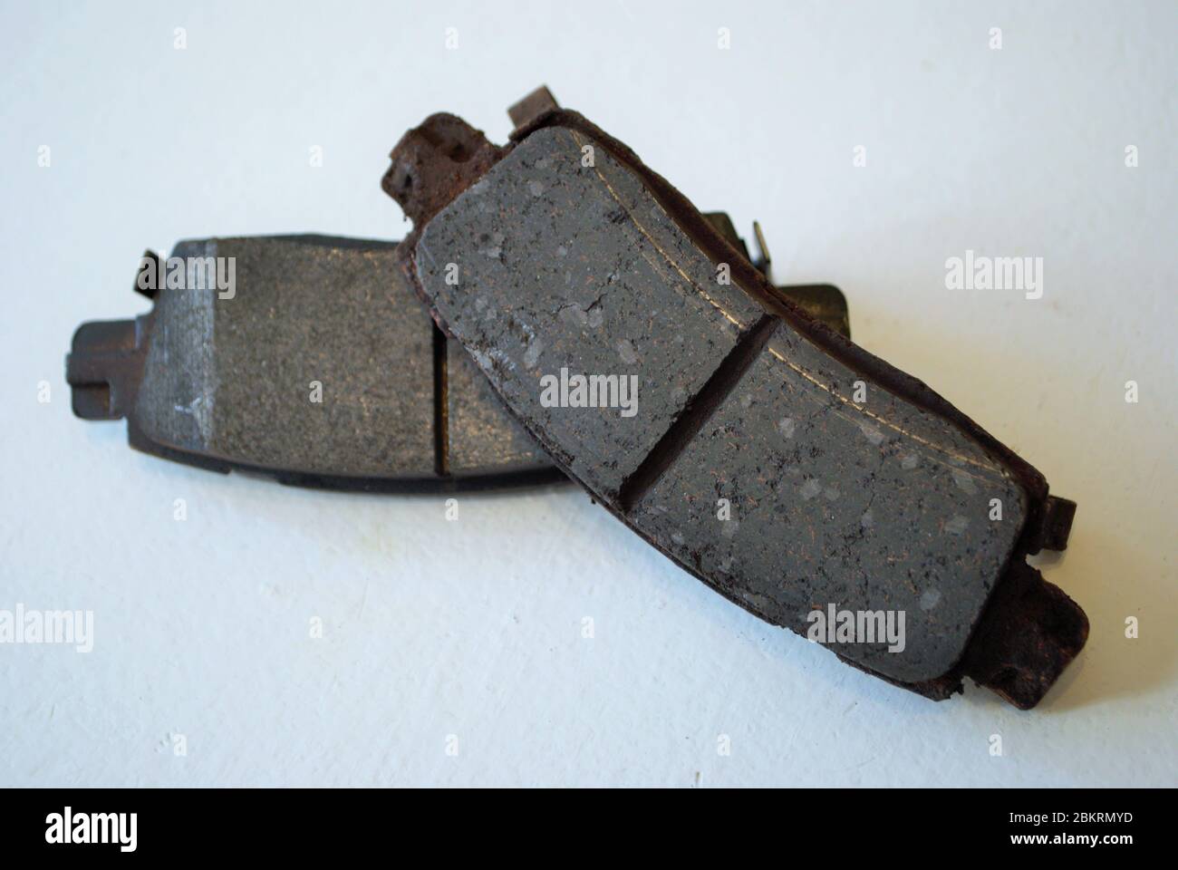 Worn out ruined disc brake pad compared to one that is new Stock Photo