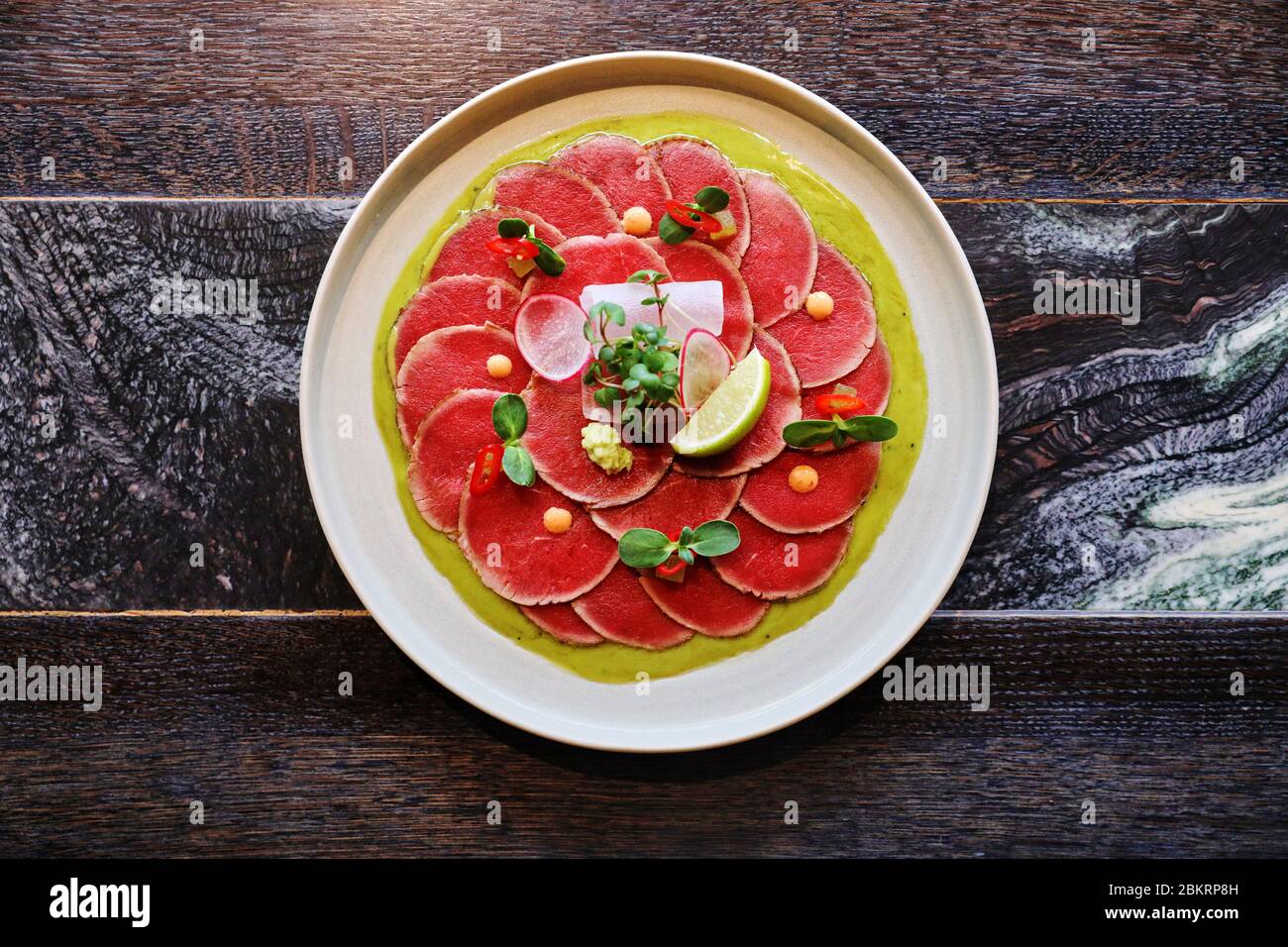 tuna carpaccio with Parmesan cheese, on dark background Stock Photo - Alamy