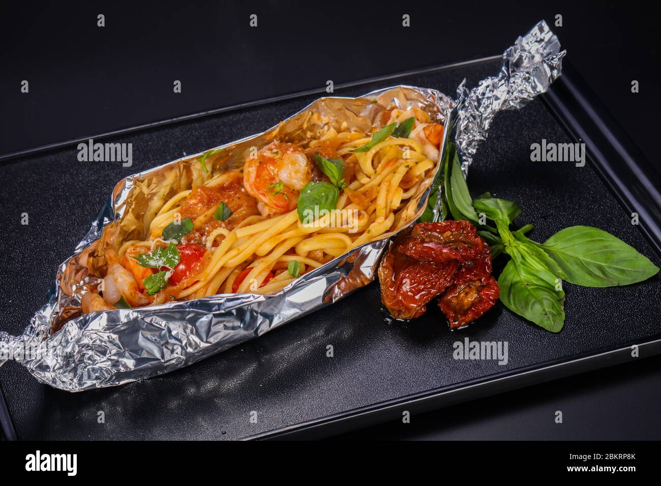 Spaghetti with prawn and tomato served basil Stock Photo - Alamy